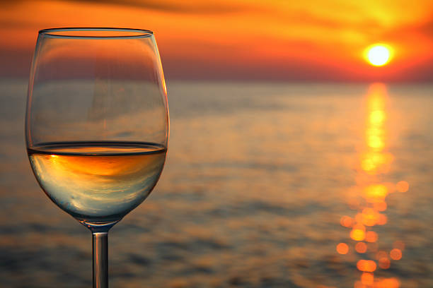 Beautiful red sunset  and glass of wine stock photo