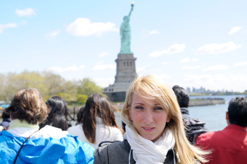 Tourists on the ferry to Statue of Liberty,NYC.Blurred background