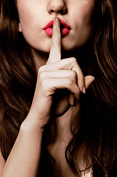 shhh - finger on lips whispering secrecy women - fotografias e filmes do acervo