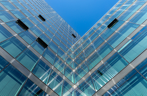 Low angle view of modern building with glass facade against clear sky, Berlin Charlottenburg