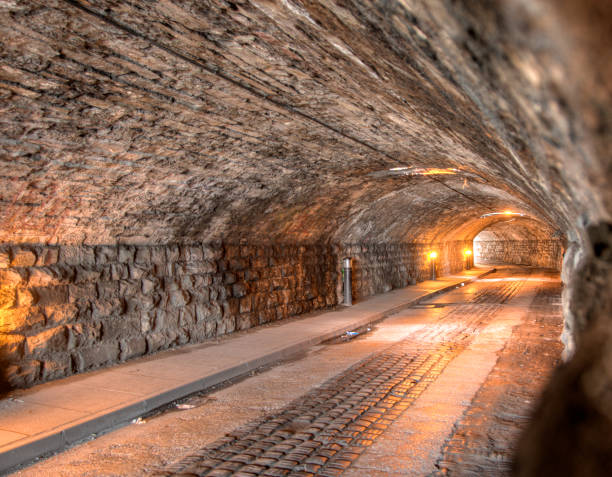istock Cobblestoned illuminated tunnel 157590187