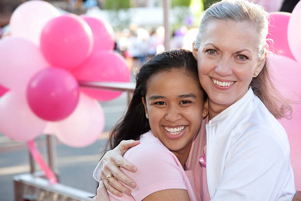 istock Two Women Hugging at a Cancer Awareness Rally 157590575