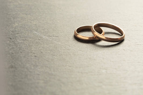 istock Wedding rings leaning against a rock surface, shallow depth of field 1575906959