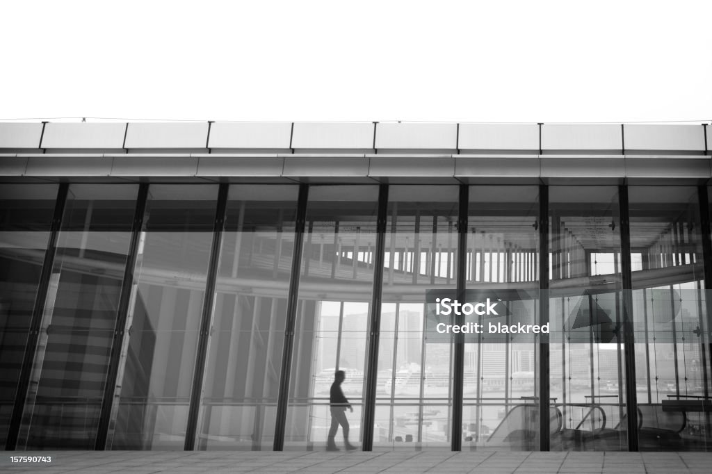 Businessman Walking by the Window  Black And White Stock Photo