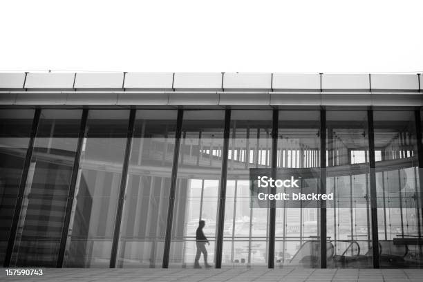 Businessman Walking By The Window Stock Photo - Download Image Now - Black And White, Hong Kong, Architecture