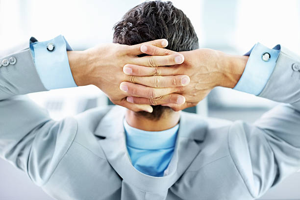 istock Relaxed business person sitting with hands behind head 157590762
