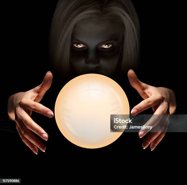 Mysterious Fortune Teller Gazes Into Crystal Ball Seeing The Future Stock Photo - Download Image Now