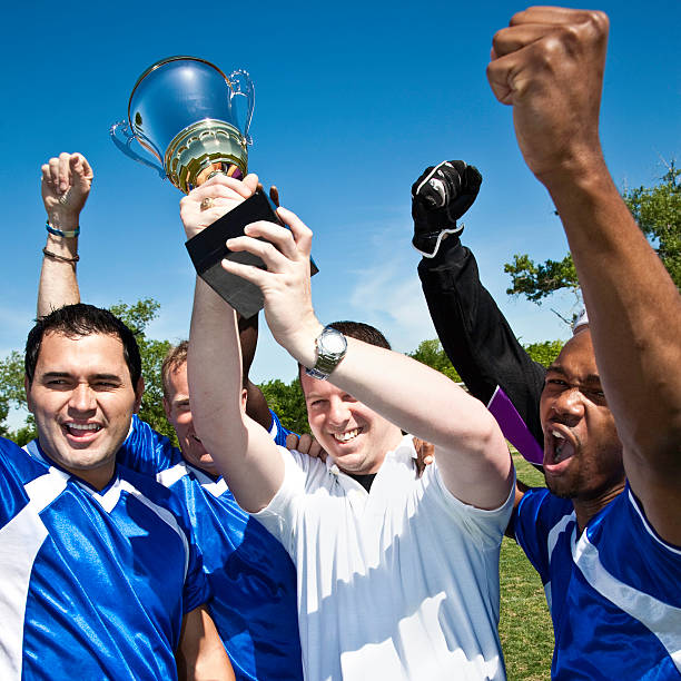 istock Soccer Team Holding Up Championship Trophy 157591525