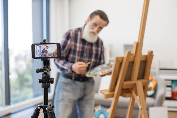 istock Senior art teacher having online class using cellphone 1575918531