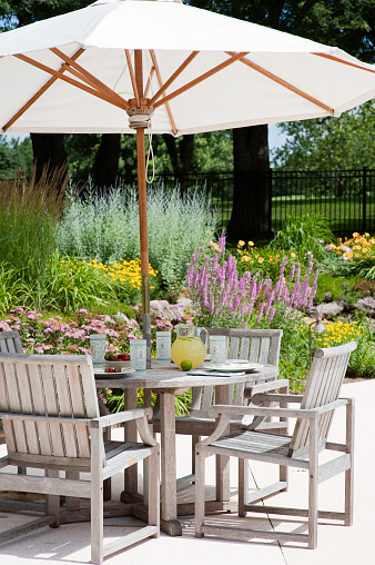 A spacious deck with a fire pit table heater