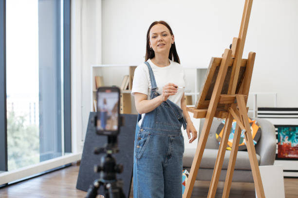 istock Artist using tripod with cellphone for online broadcast 1575919099