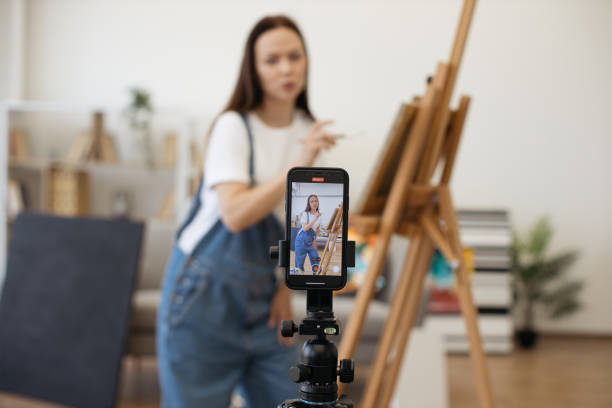 istock Female blogger using cellphone for shooting video content 1575919108
