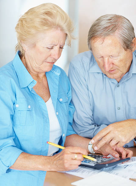 istock Worried senior couple calculating their bills 157591999