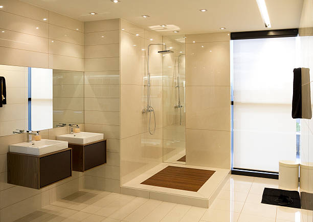Luxurious bathroom with natural lighting from windows stock photo