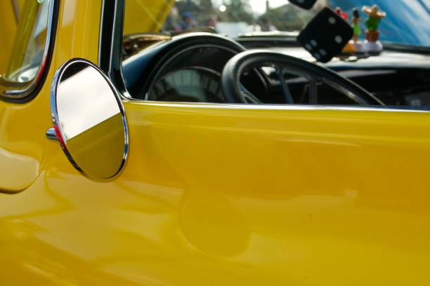 Closeup of the driver’s side of a vintage yellow pickup truck Closeup of the driver’s side of a vintage yellow pickup truck vintage steering wheel stock pictures, royalty-free photos & images
