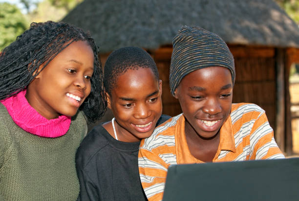 istock African children looking at Laptop 157592298