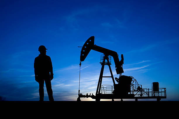 istock Blue Dusk Pumpjack and Oil Worker 157592314