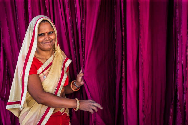 Colors of India - woman checking dyed fabrics, Rajasthan, India Indian woman checking freshly dyed fabric hanging to dry, sari factory, Rajasthan, India, Asia india indigenous culture indian culture women stock pictures, royalty-free photos & images