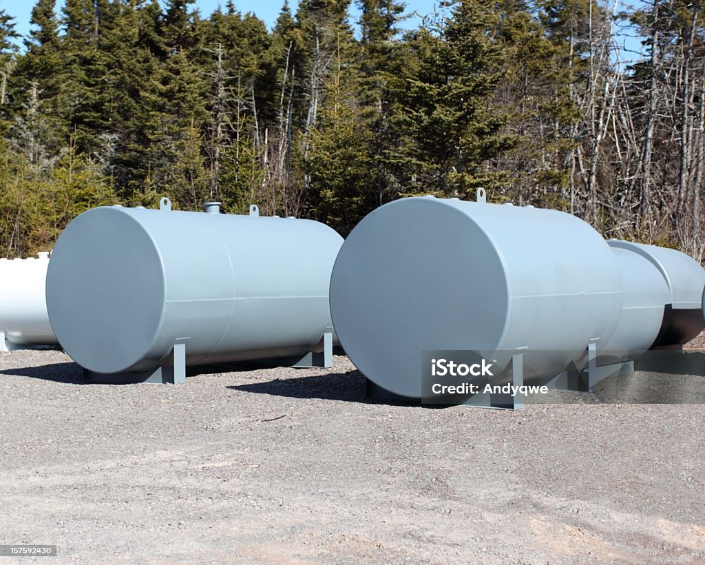 New fuel tanks in a gray color New tanks that have just been fabicated and have not been used yet. Selective focus on forward grey tanks. Foreground and background out of focus. Fuel Storage Tank Stock Photo