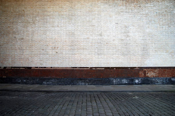 Urban background UK - White brick wall with sidewalk
