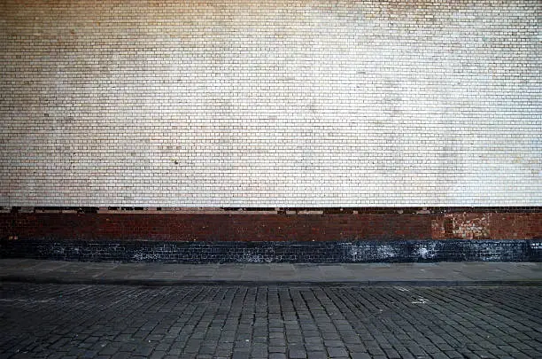 Photo of Urban background UK - White brick wall with sidewalk