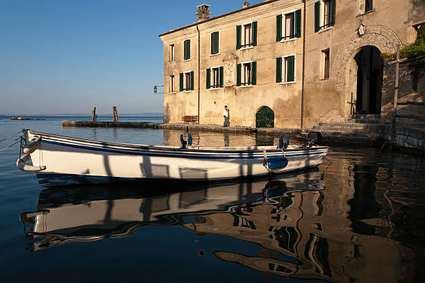 Punta San Vigilio is a small promontory stretching into the lake, surrounded by cypresses and olive trees. It is one of the jewels of Lake Garda, known worldwide for its romantic atmosphere. Lake Garda, Italy. 
