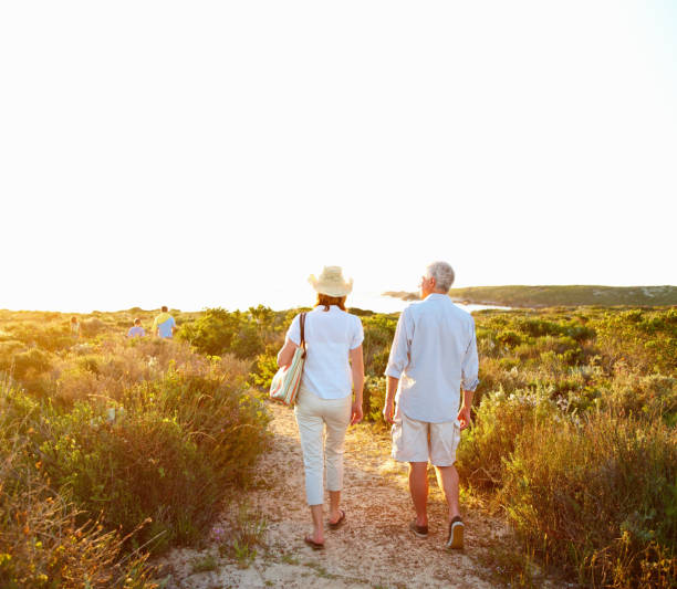 istock Rear view of a retired couple walking together 157592603