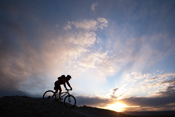 istock mountain biking silhouette sunset sky 157592818