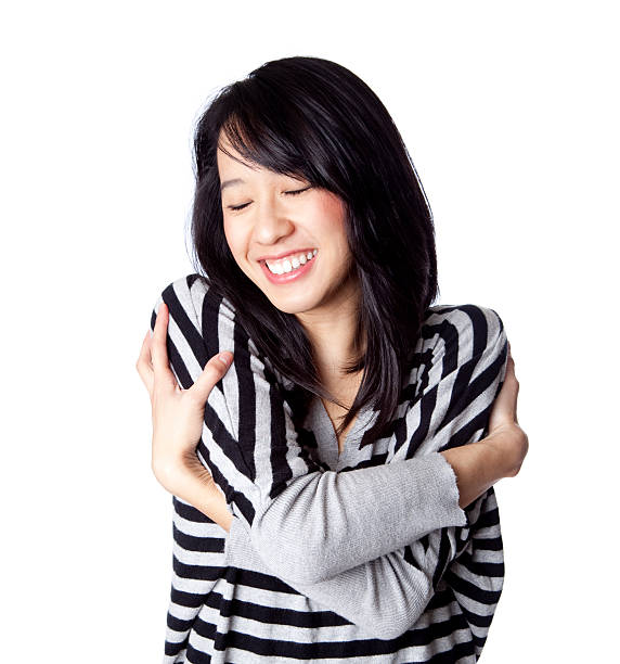 istock happy young Asian woman hugging herself 157593060