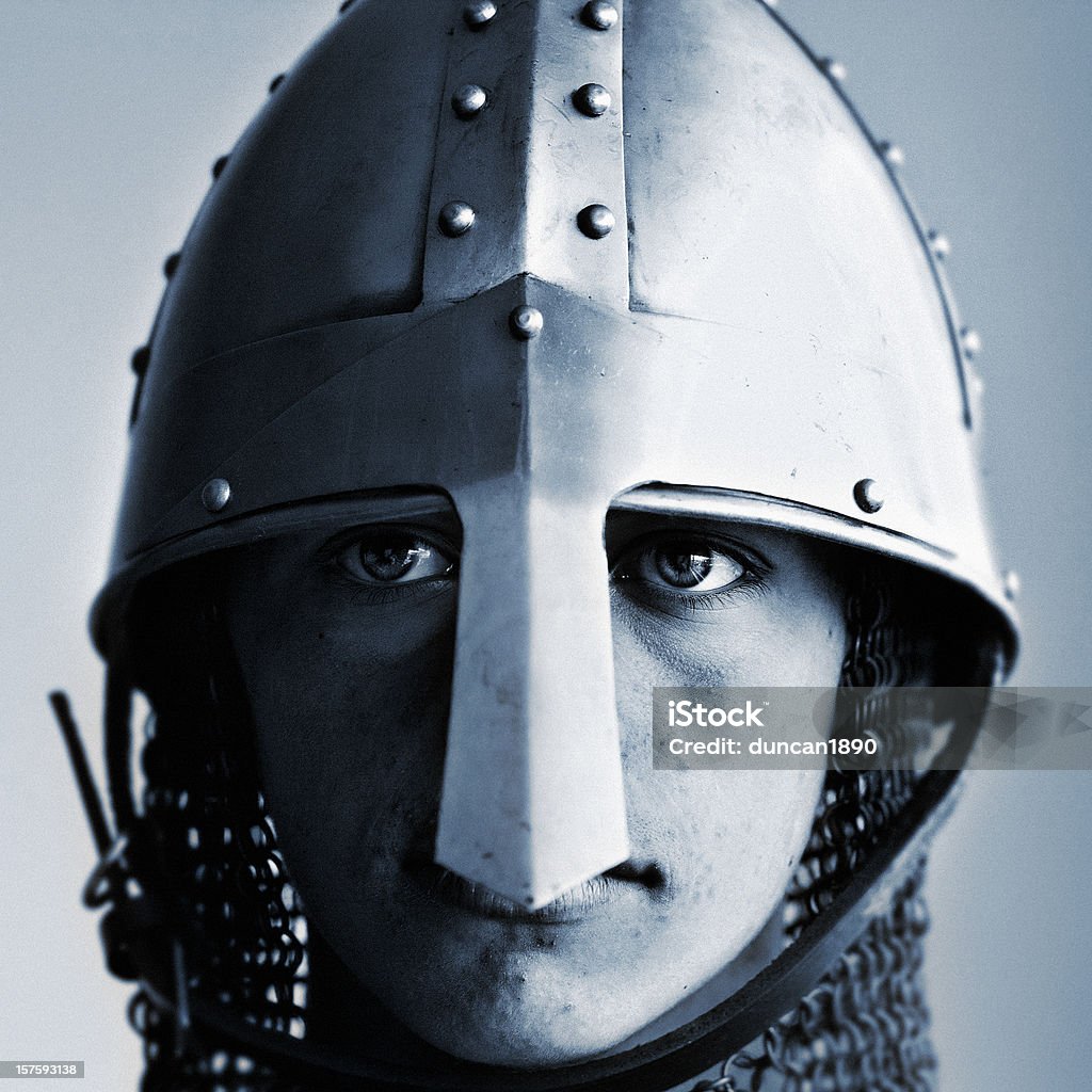 Young Norman Knight Portrait of a teenage boy wearing the helmet and chain mail armour of a norman knight Ancient Stock Photo