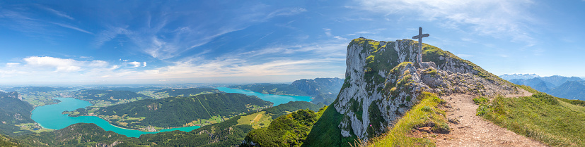 panoramic landscape with top of Mount Schafberg with cross and mountains and Lake Mondsee and Attersee, Alps, Austria