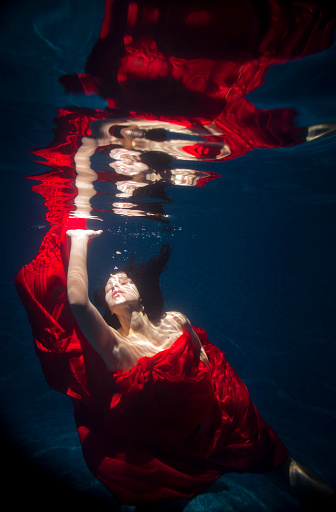 Nymph Underwater with red cloth in sun light (ranges of the light)