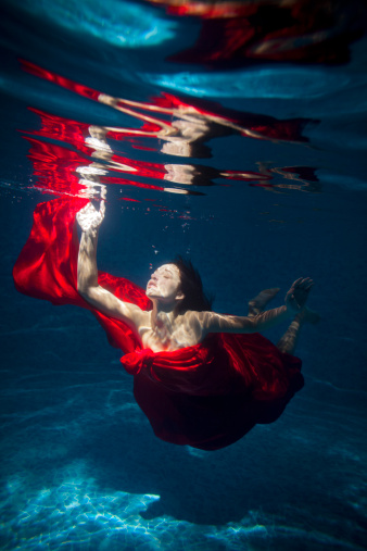 Nymph Underwater with red cloth in sun light 