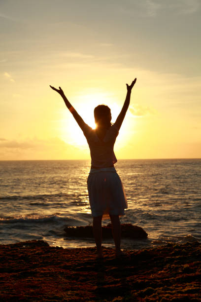 istock one young woman enjoy sunset on the beach 157593986