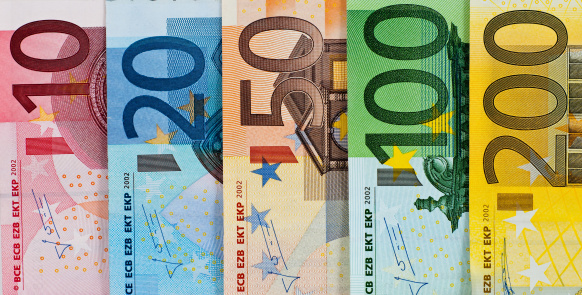 American dollars and European euros close-up, different convertible currencies of euros and dollars together