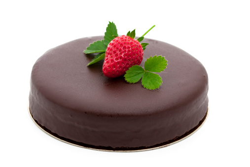 close-up of chocolate cake with strawberry isolated on white