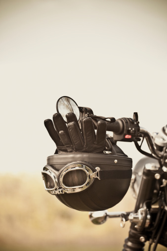 Vintage leather helmet and gloves on vintage motorcycle handlebars. Short depth of field. Shot with 5DII.