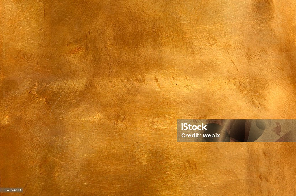 Metal copper background abstract scratchy mottled texture XL Brushed brown-golden copper or bronze surface, with visible brush strokes. The sheet metal has an appealing cloudy, wavy texture. Horizontal orientation. The image has been shot outdoors during natural day light, full frame and close up. Ideal for backgrounds. The dimensions of the photo are 4223 x 2805 px Textured Stock Photo