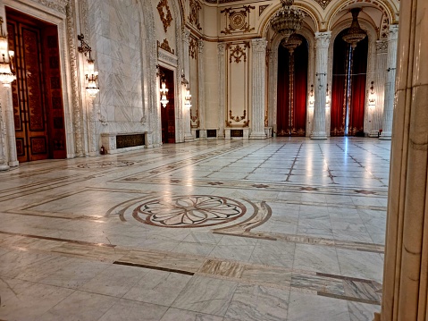 The Palace of the Parliament is the seat of the Parliament of Romania. The Palace of the Parliament is one of the heaviest buildings in the world, constructed over a period of 13 years (1984–1997). The image shows a large room inside the Parliament Building.