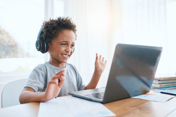 istock Happy, remote and a child waving on a video call for education, elearning and online class on laptop. Smile, wave and a student greeting for digital school communication from home on a computer 1575952700