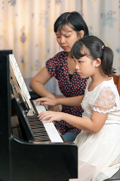 istock Asian girl playing piano 157597118