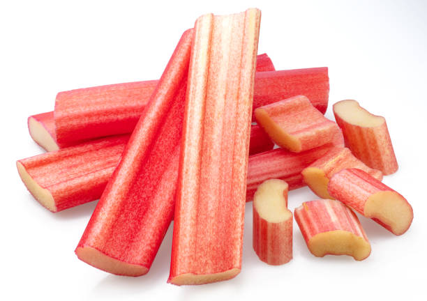 istock Rhubarb stems' cuts isolated on white background. 1575979198