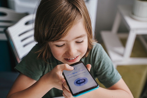 Child using system AI Chatbot in computer or mobile application. Chatbot conversation, Ai Artificial Intelligence technology. OpenAI generate. Futuristic technology. Virtual assistant on internet.