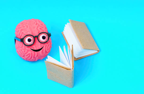 istock Book Lover's Mind: Brain Character with Googly Eyes and Glasses 1575987282