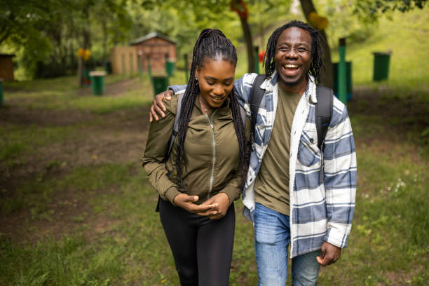 istock Portrait of a young couple backpacking through a forest 1576006188
