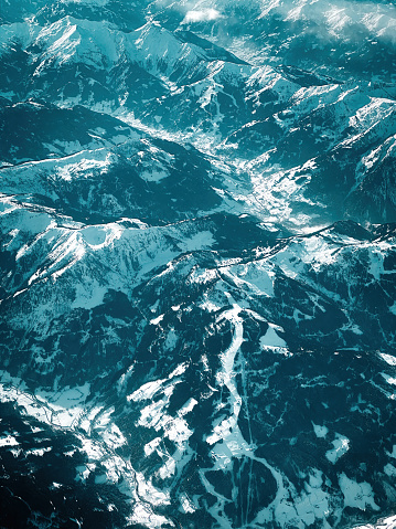 Aerial view of Wagrain ski region and of snow covered mountains in Austrian alps in Winter