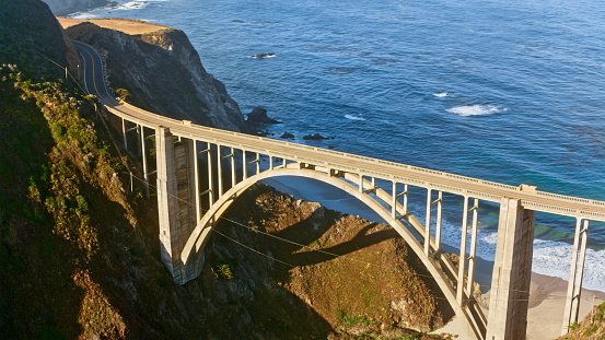 Aerial view of Bixby Creek Bridge during sunny day in Monterey County, California, USA.