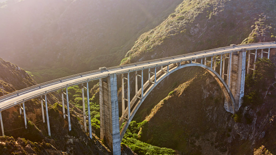 Aerial view of Bixby Creek Bridge during sunny day in Monterey County, California, USA.