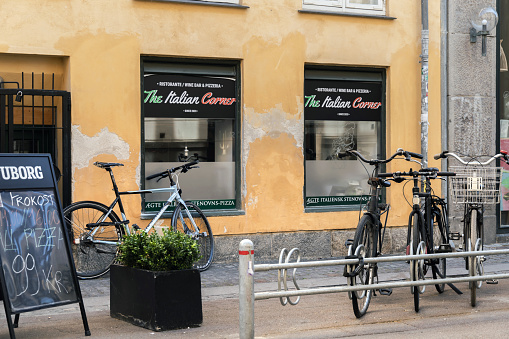 Copenhagen, Denmark - July 28, 2023. Copenhagen city street with bicycles parking at sidewalk. Bikes for rent.