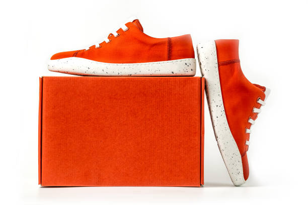 New white sneakers shoes in red box. Taken at studio and isolated over white background